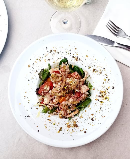 Calamari con pomodorini, spinacino e granella di pistacchi
